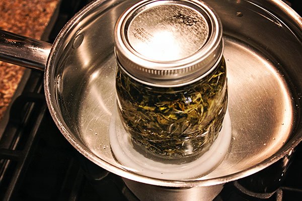 Infuse herbs in oils quickly with a hot water bath.