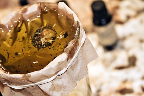 Strain the oils from the herbs using a coffee filter or cheesecloth.